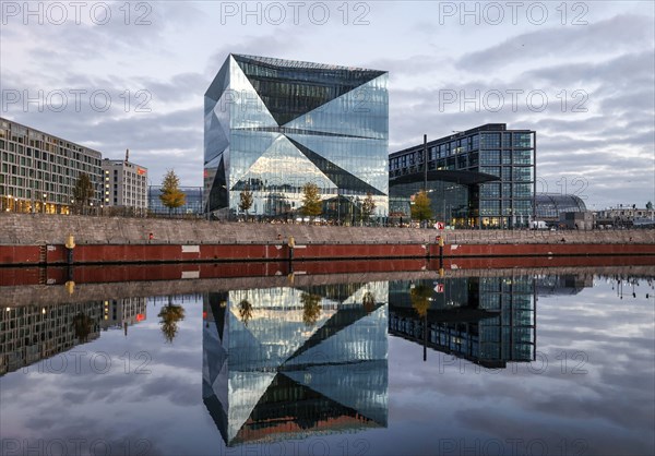 The cube Berlin building at Berlin Central Station is reflected in the River Spree