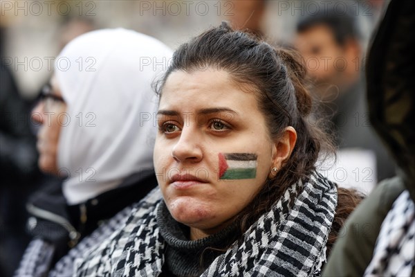A participant in the Freedom for the People of Gaza demonstration has painted the Palestinian flag on her cheek