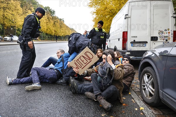 Police officers carry last generation climate activists from Strasse des 17. The Last Generation has called for a mass occupation action