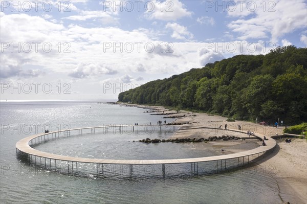 An aerial view shows people walking on the infinite bridge. The bridge is a work of art built by Sculpture by the Sea