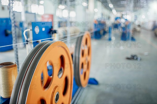 Industrial production of fiber optic cable for telecommunication systems. Manufacturing of modern fiberglass and fiber optic cables at the factory