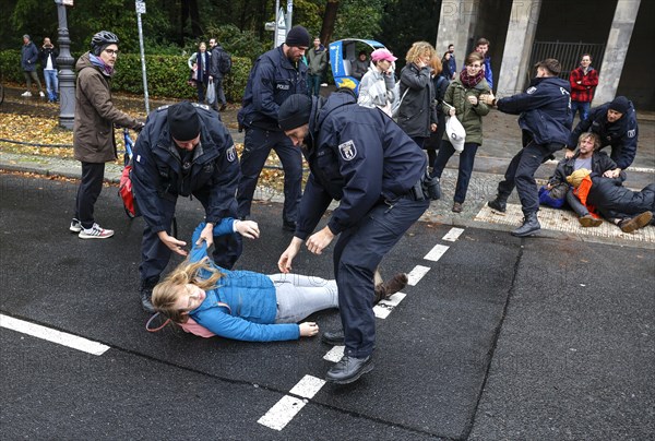 Police officers carry last generation climate activists from Strasse des 17. The Last Generation has called for a mass occupation action