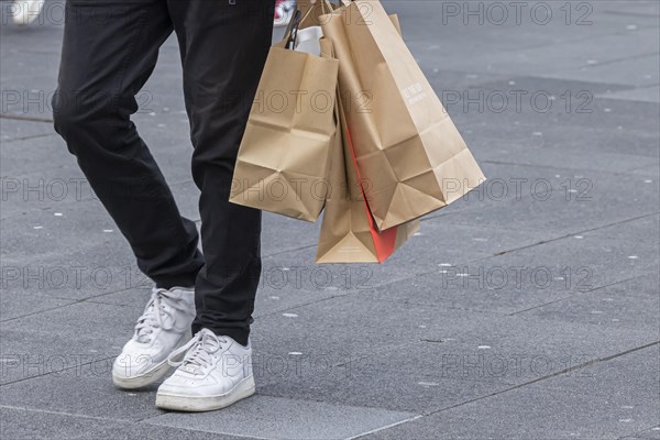 Consumer tourist lugging shopping bags