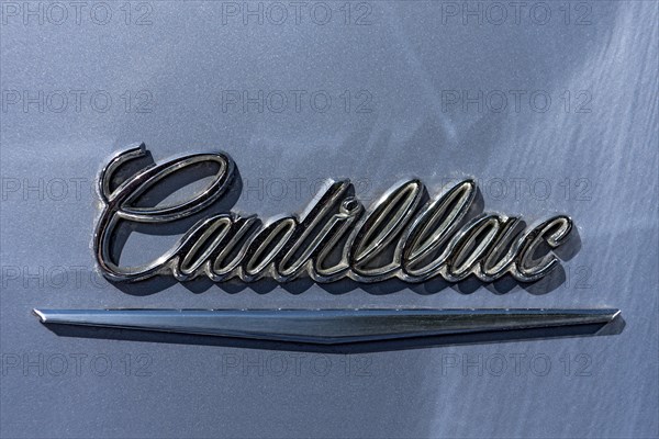 Lettering brand name Cadillac on vintage car Coupe DeVille at the rear