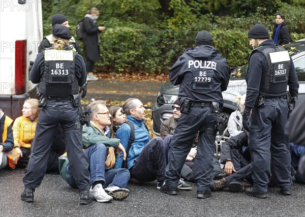 Police officers carry last generation climate activists from Strasse des 17. The Last Generation has called for a mass occupation action