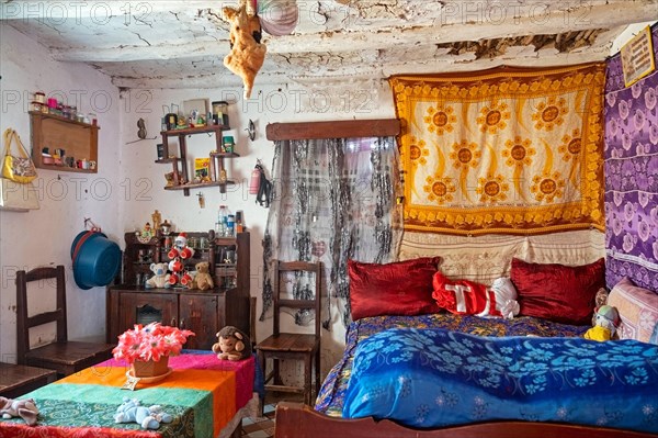 Interior of Betsileo house showing living room with bed in the Haute Matsiatra Region