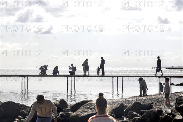 People walking on the infinite bridge . The bridge is a work of art built for Sculpture by the Sea