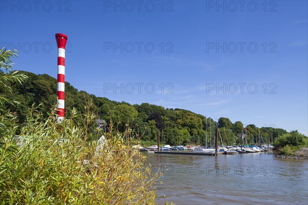 Dinghy harbour or Muehlenberg marina with lighthouse on the Elbe