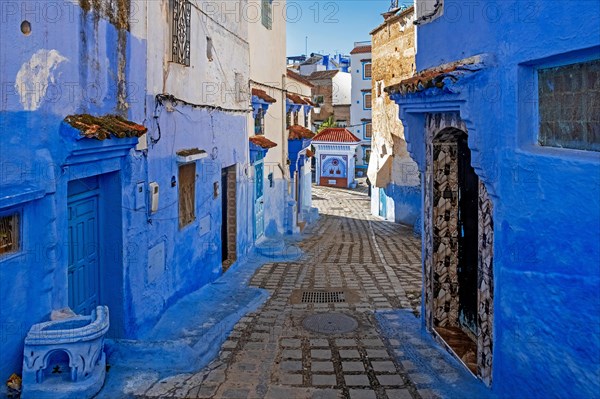 Narrow alleyway with blue walls