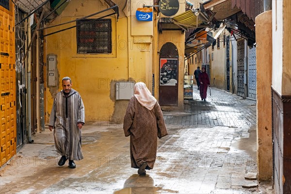 Muslim man and women wearing djellabas