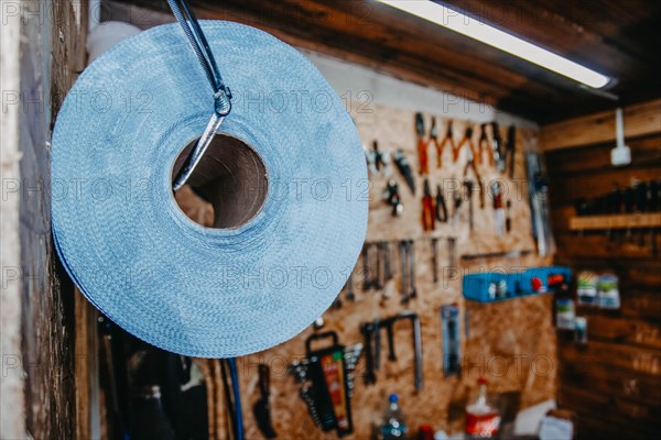 Auto mechanic tools and paper towels hanging on the wall in a car service center