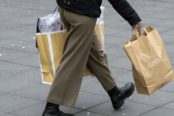 Consumer tourist lugging shopping bags