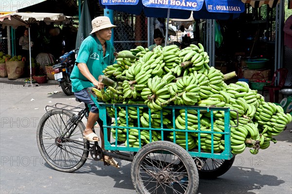 Man with tricycle full of bananas