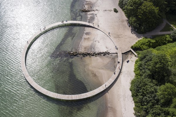 An aerial view shows people walking on the infinite bridge. The bridge is a work of art built by Sculpture by the Sea