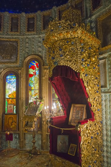 A richly decorated iconostasis with paintings and gold ornaments in a church