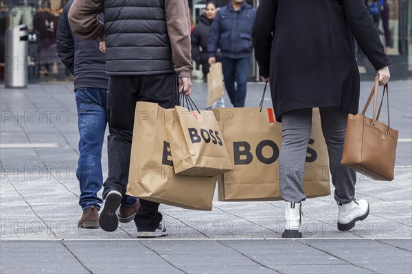 Consumer tourist lugging shopping bags