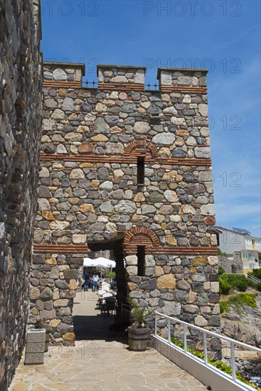 Old stone gate of a fortress under a clear blue sky