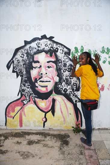 Tour guide Susan Maxwell in front of Bob Marley mural