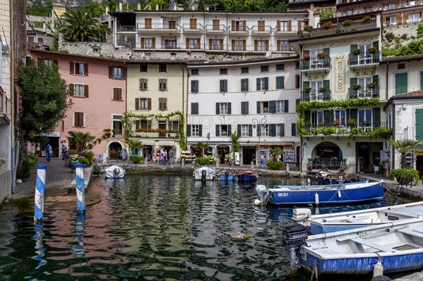 Houses and fishing boats in the old harbour of Limone sul Garda