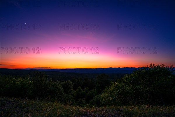 Sun sets behind the Catskills Mountains