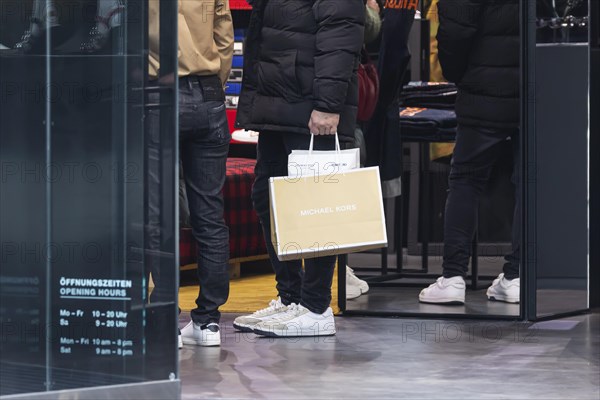 Consumer tourist lugging shopping bags