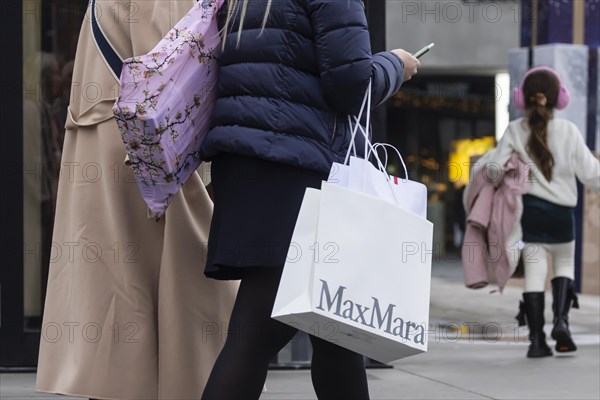 Consumer tourist lugging shopping bags