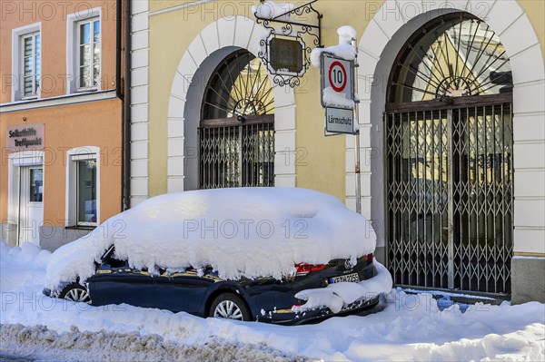 Snow-covered car with fresh snow