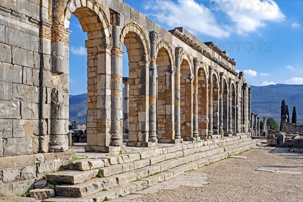 Arched outer wall of basilica faced with columns at Volubilis