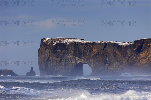 Black arch of lava near Vik i Myrdal at the Dyrholaey peninsula in winter