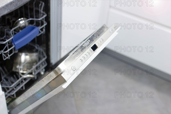 White modern dishwasher in the interior of a white kitchen