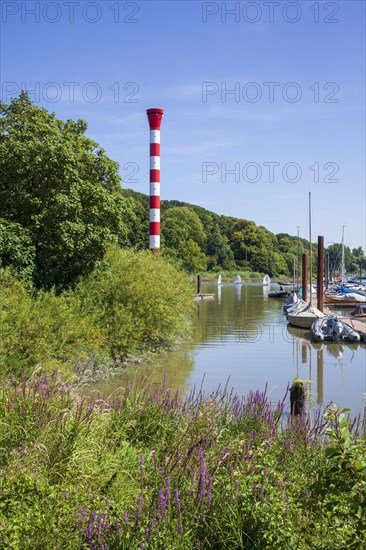 Dinghy harbour or Muehlenberg marina with lighthouse on the Elbe