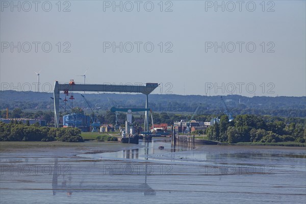 Shipyard crane Jucho and bridge at the mouth of the river Este into the Elbe