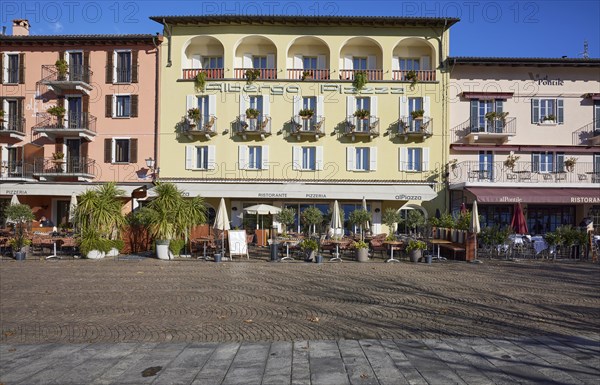 Restaurants in pastel-coloured houses on the Piazza Giuseppe Motta promenade in Ascona