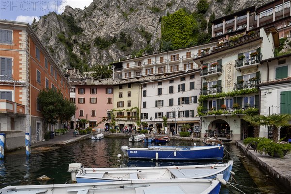 Houses and fishing boats in the old harbour of Limone sul Garda