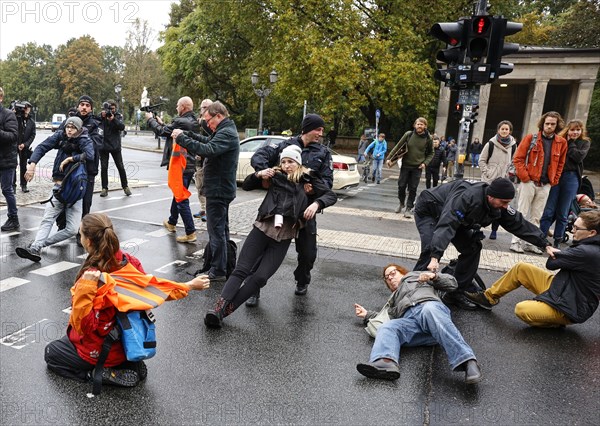 Police officers carry last generation climate activists from Strasse des 17. The Last Generation has called for a mass occupation action