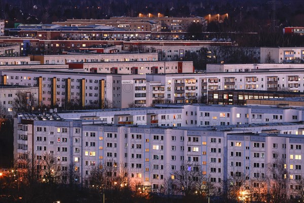 View in the evening at blue hour of high-rise buildings and apartment blocks with rental flats and condominiums in the Berlin district of Marzahn-Hellersdorf