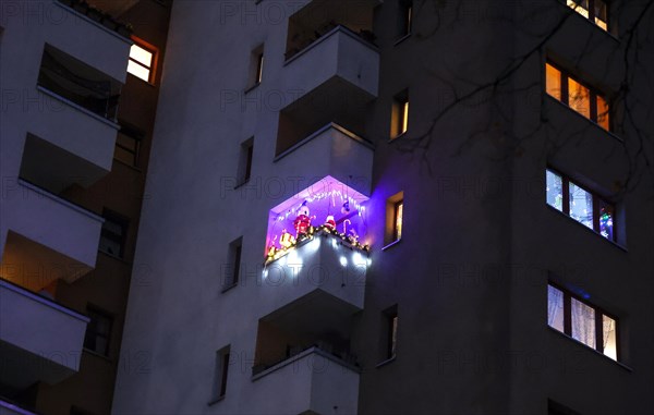 Balcony decorated for Christmas with LED fairy lights on a high-rise building in the Maerkisches Viertel