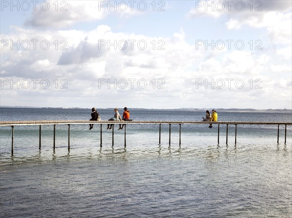 People walking on the infinite bridge . The bridge is a work of art built for Sculpture by the Sea