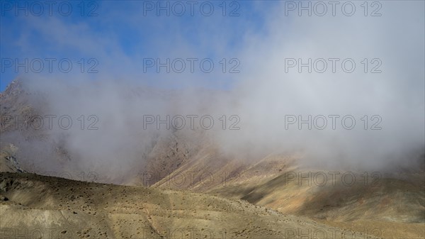 Low hanging clouds in the mountain landscape at the Tizi-n-Tichka pass road, High Atlas, Morocco, Africa