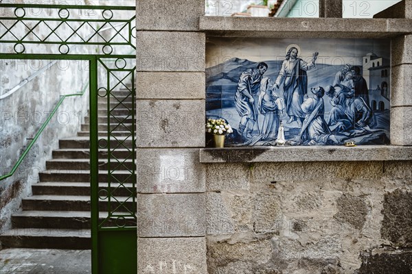 Holy Mary statue with the religious background made of Portuguese traditional tiles, Porto, Portugal, Europe