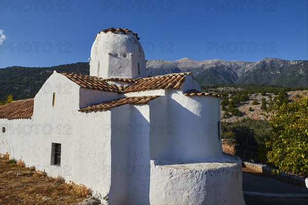 Church of St Michael the Archangel, Cross-domed church, White church with rounded dome against an imposing mountain backdrop and blue sky, Aradena Gorge, Aradena, Sfakia, Crete, Greece, Europe