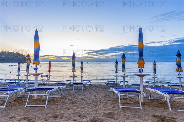 Sun loungers and parasols on Straccolignino beach at sunrise, near Capoliveri, Elba, Tuscan Archipelago, Tuscany, Italy, Europe