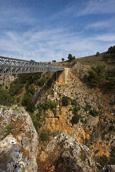 An iron bridge spans a gorge under a blue sky, Aradena Gorge, Aradena, Sfakia, Crete, Greece, Europe