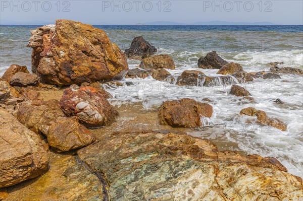 Mineral rocks washed by the sea on the beach of Topinetti, near Rio Marina, Elba, Tuscan Archipelago, Tuscany, Italy, Europe