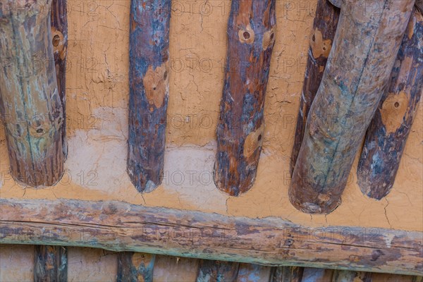 Closeup of logs and mud in ceiling of old log cabin