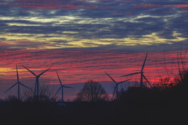 Silhouettes of wind turbines against a red evening sky, open-cast lignite mine, North Rhine-Westphalia, Germany, Europe