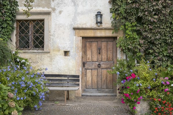 House entrance with lush floral decorations, Mitterdorf, Kaltern, South Tyrol, Trentino-South Tyrol region, Italy, Europe