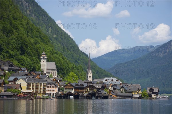 Hallstatt, a charming village on the Hallstattersee lake and a famous tourist attraction, with beautiful mountains surrounding it, in Salzkammergut region, Austria, in summer sunny day, Europe