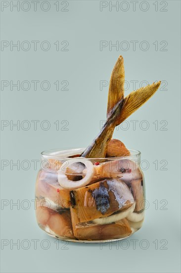Transparent glass pot with sliced mackerel marinated with pepper and onion