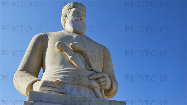 Statue of the resistance fighter and partisan Yannis Daskaloyannis, Imposing statue of a dignified man in front of a bright blue sky, Anopolis, Sfakia, West Crete, Crete, Greece, Europe
